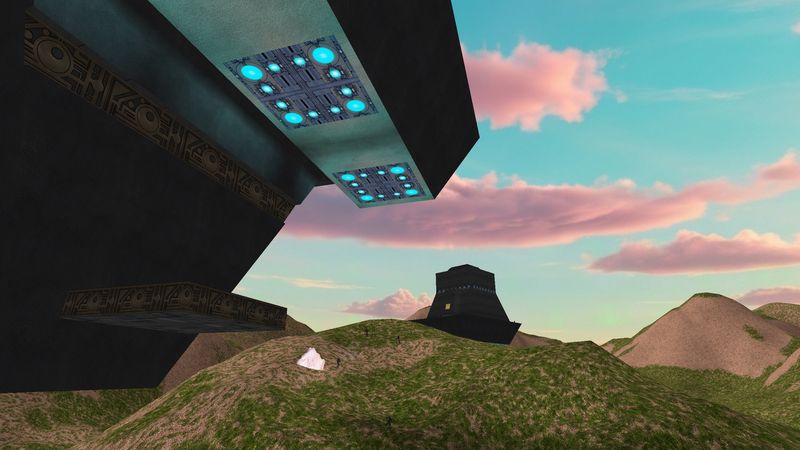 Looking up at a tower underside with glowing light panels at dusk